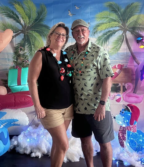 A couple is dressed up with festive accessories for the Christmas in July Party at The Meadows, a 55+ community in Tarpon Springs.