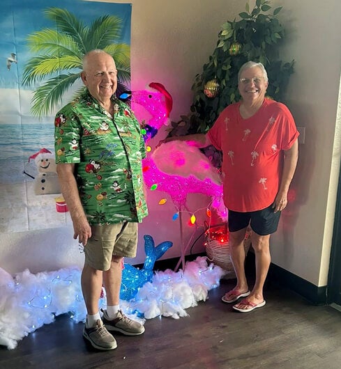 A couple is dressed up with festive accessories for the Christmas in July Party at The Meadows, a 55+ community in Tarpon Springs.