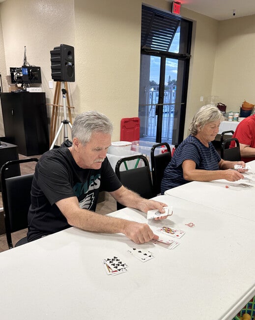 55+ Residents at The Meadows play with cards during Game Night