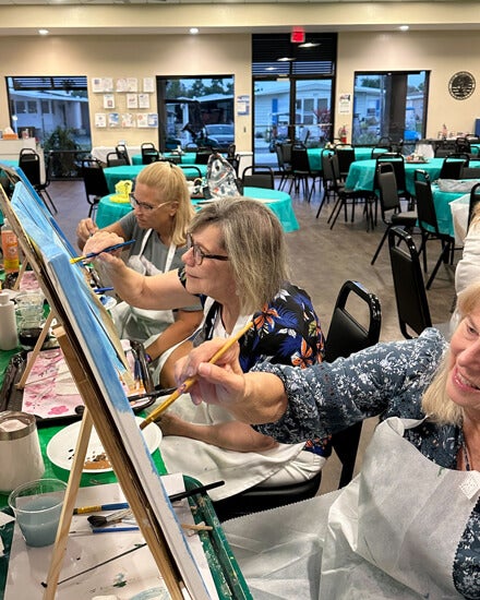 55+ residents painting canvases at The Meadows in Tarpon Springs, FL.