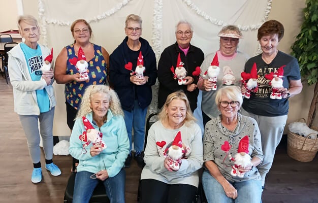 55+ residents holding gnome creations from a craft class at The Meadows in Tarpon Springs, FL.