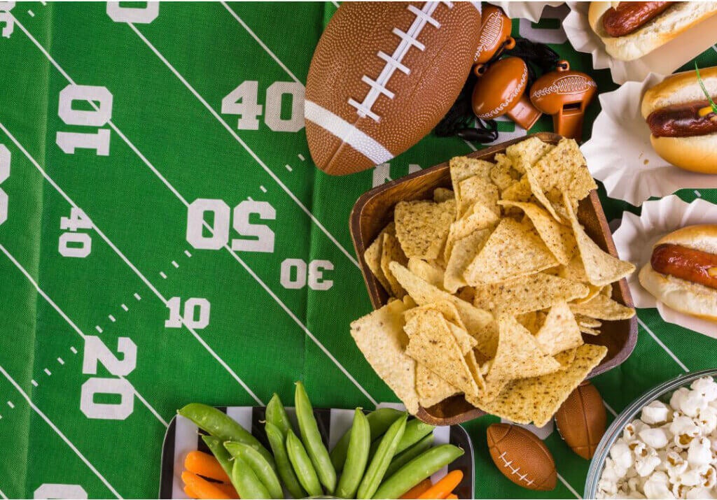 Spread of hotdogs, snacks, and appetizers for a football party