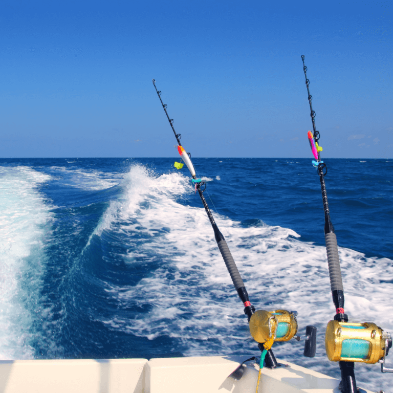 View of the back of the boat in the ocean while sailing with two fishing pools.