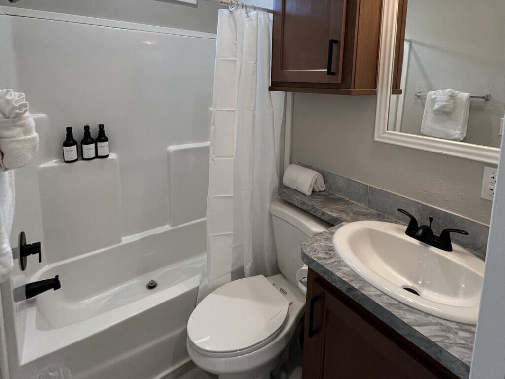 Bathroom showing a shower, toilet, and sink inside of a vacation rental at Big Pine Key RV Park in Florida.