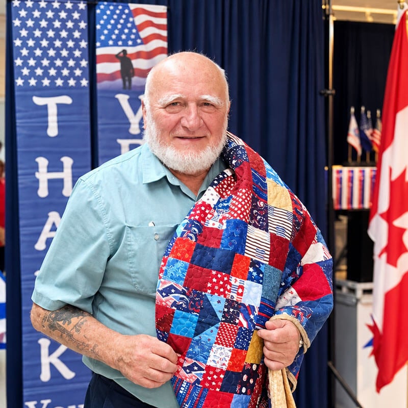 Veteran is recognized in the Quilt of Valor ceremony at Holiday RV Park.