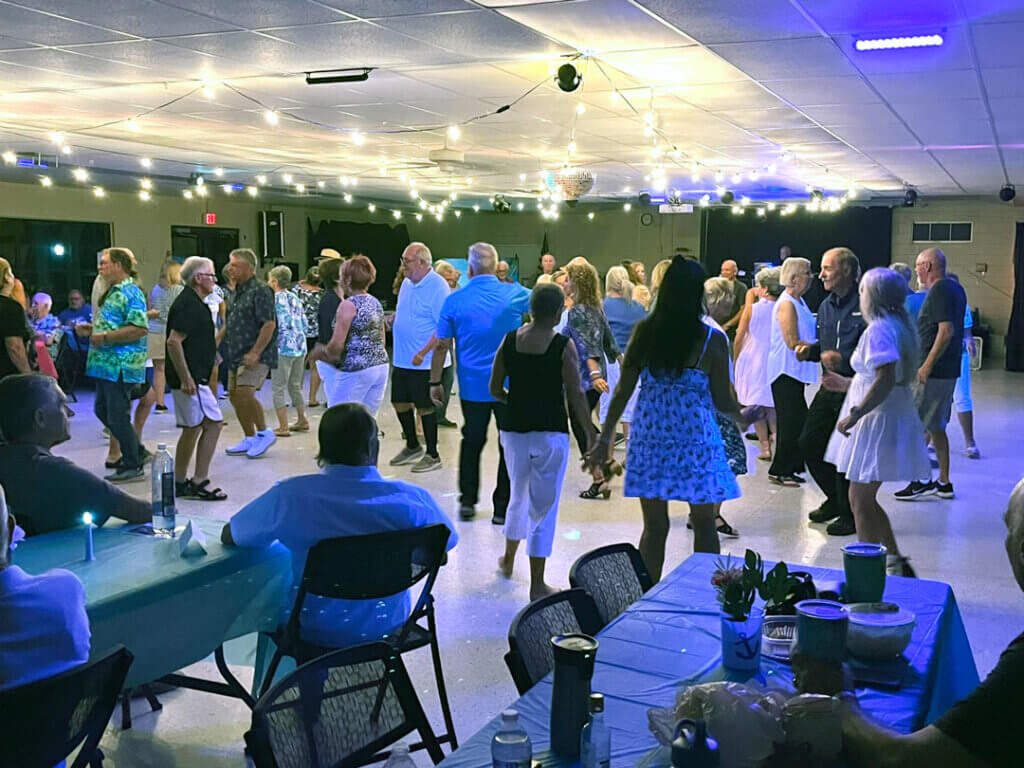 Guests at Holiday RV Park are dancing at the Yacht Club Dance with live music by DJ Bob.