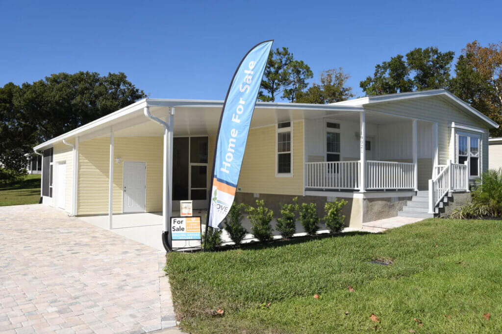 A yellow manufactured home for sale in Ocala, FL at Rolling greens Village.