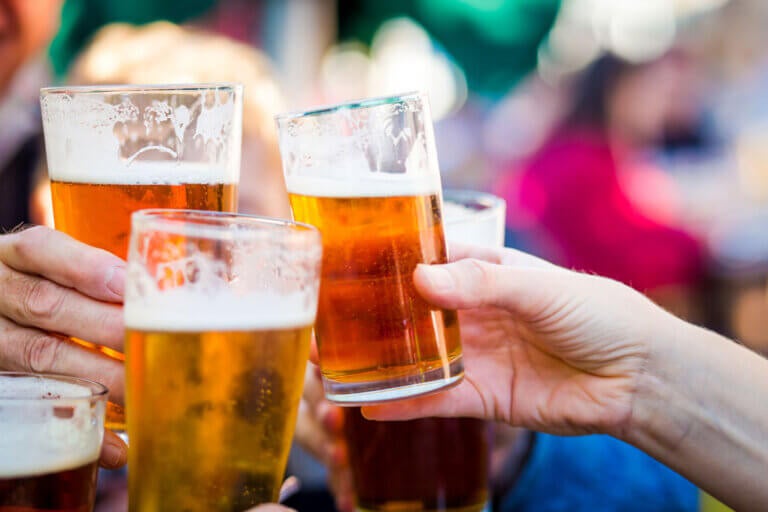 3 glasses of beer during a toast CREDIT: iStock