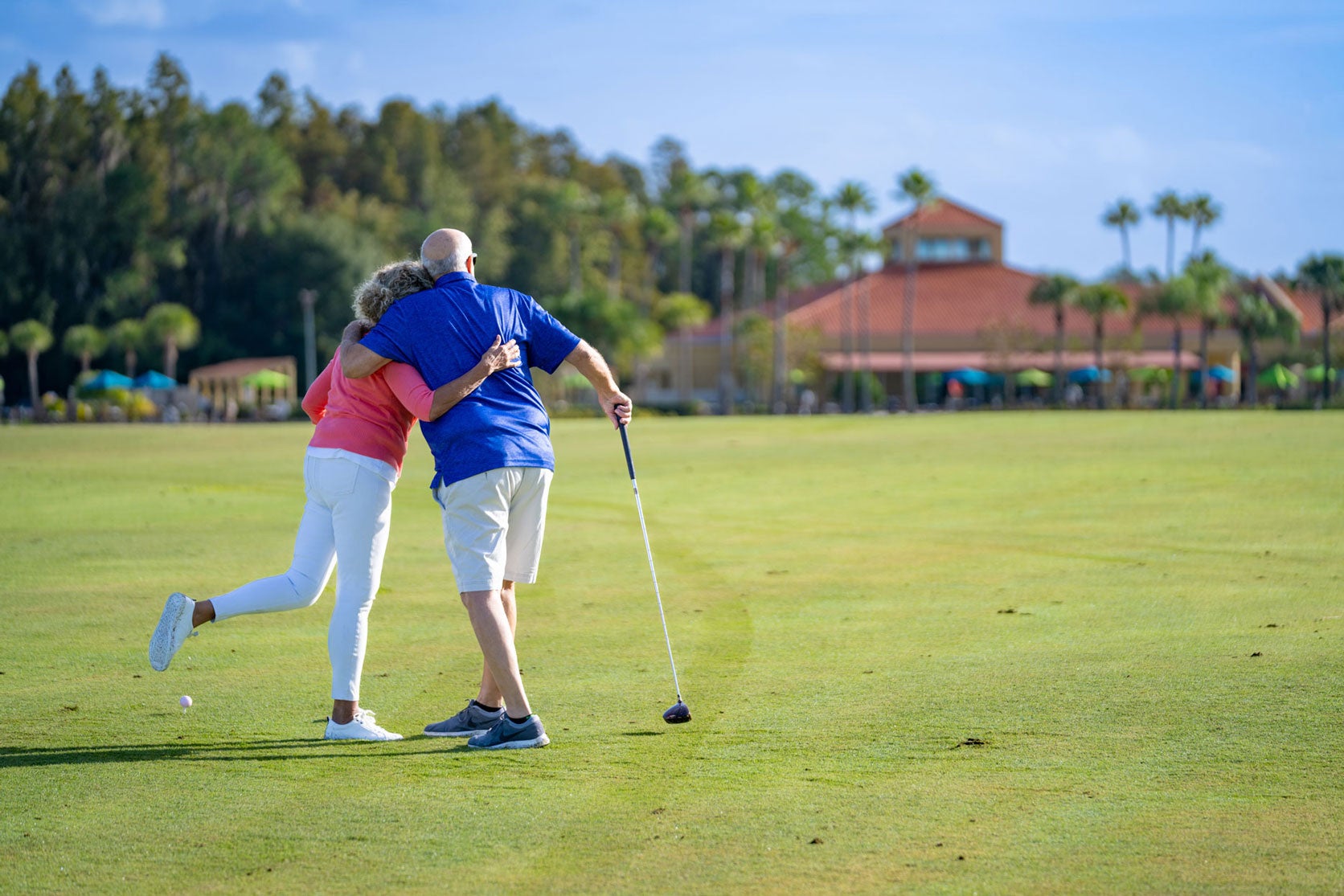 Couple hugging on the fairway at Cypress Lakes Village in Lakeland, Florida.