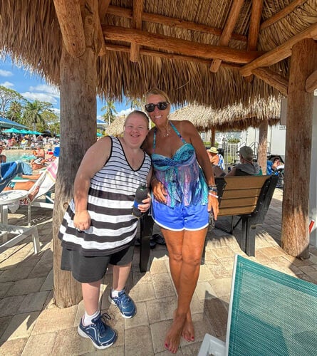 Guests in the tiki hut by the community pool at Blueway RV Park in Fort Myers, Florida.