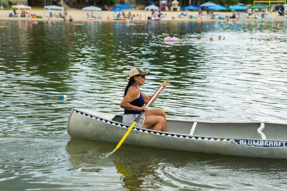 A woman paddling in a canoe on Sebago Lake in Casco, Maine.