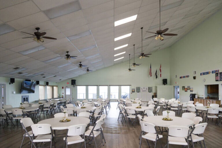 Tables and chairs inside the clubhouse at Lake Griffin Harbor Village in Leesburg, Florida.