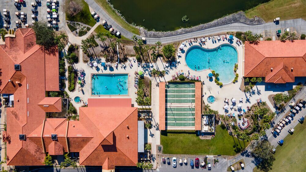 View of the resort amenities including the swimming pool and clubhouse at Cypress Lakes Village