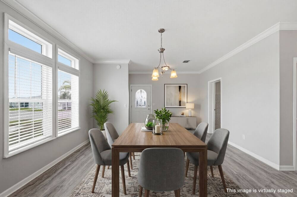 dining-room-house-estero-bay A dining room table surrounded by chairs inside a staged home at Estero Bay Village in Florida.