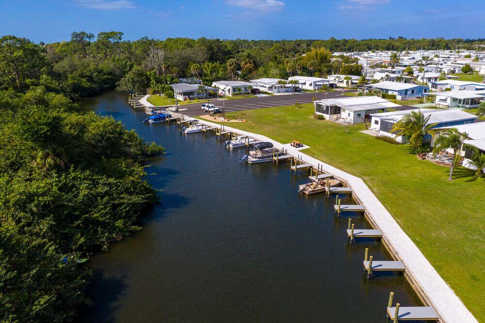 Home sitting along the bank of the Estero River with docks and boats at Estero Bay Village.