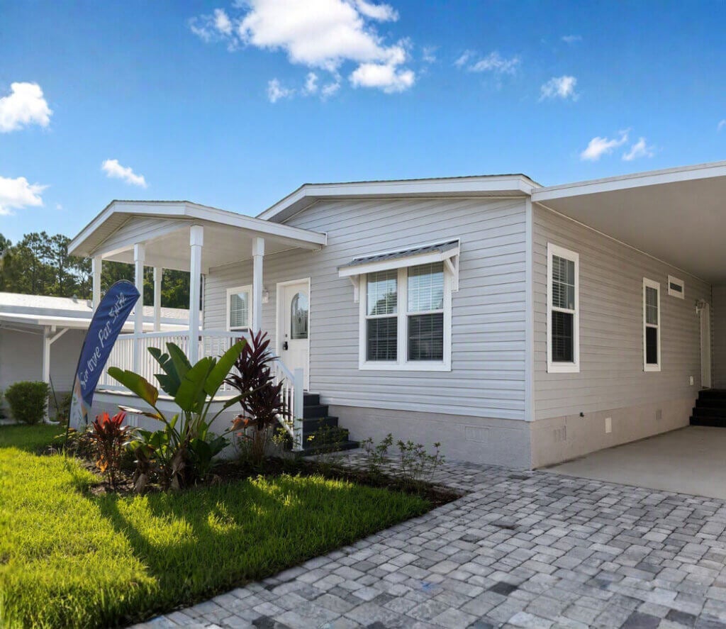 A home for same with landscaping and a carport at Meadowlea Village in Florida.