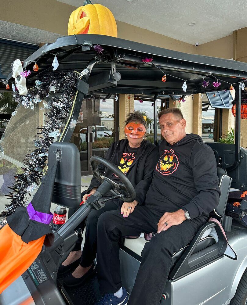 Residents dressed up in costumes in decorated golf carts for a halloween golf cart parade through The Meadows in Tarpon Springs, Florida.