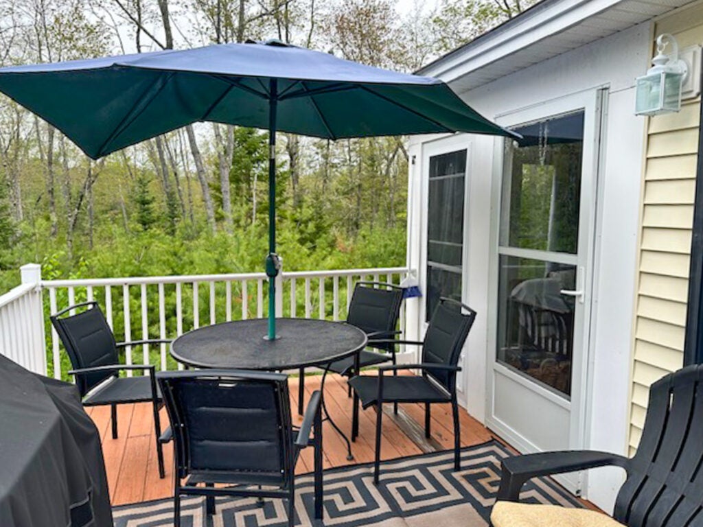 Table and chairs with an umbrella above the table