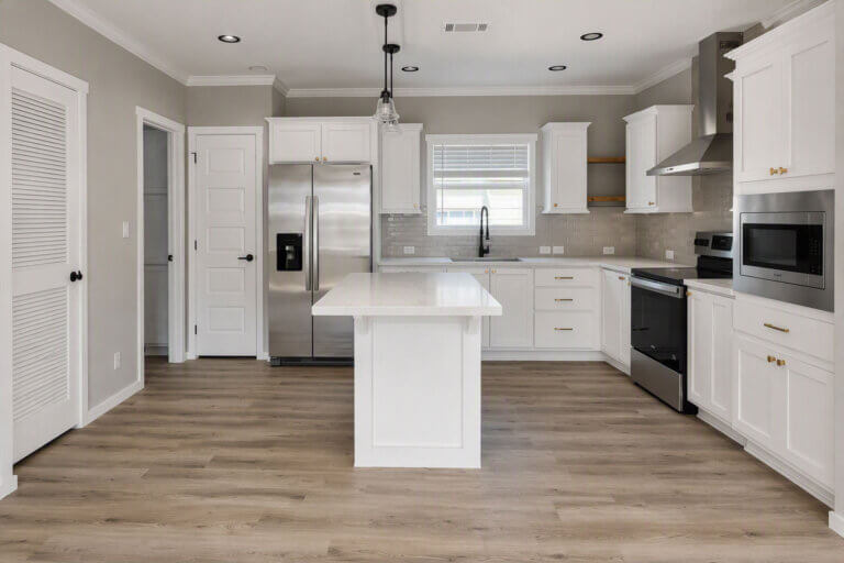 A clean, modern kitchen inside a manufactured home for sale in Bear Creek Village, Ormond Beach, Florida.