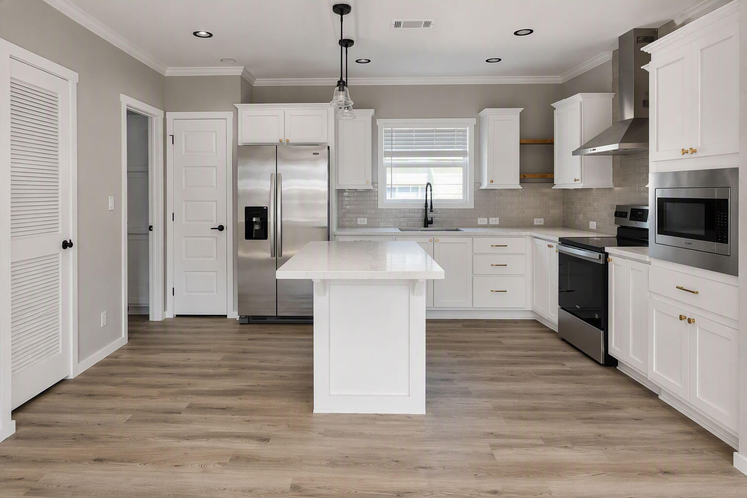 A clean, modern kitchen inside a manufactured home for sale in Bear Creek Village, Ormond Beach, Florida.