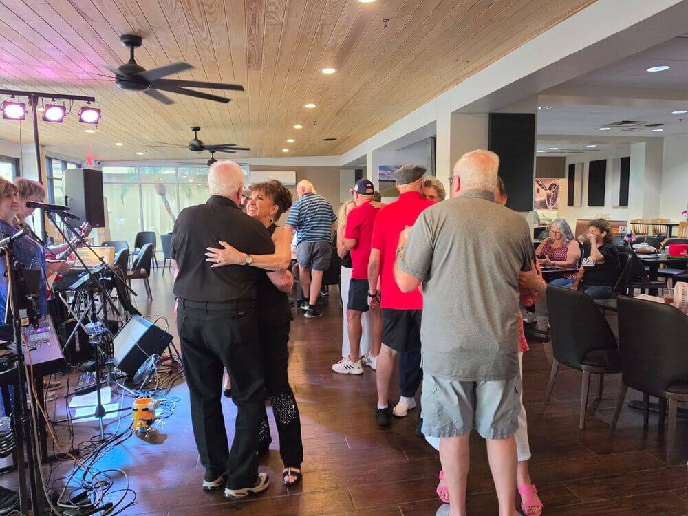 Residents dancing together to live music at Big Cypress Grill.