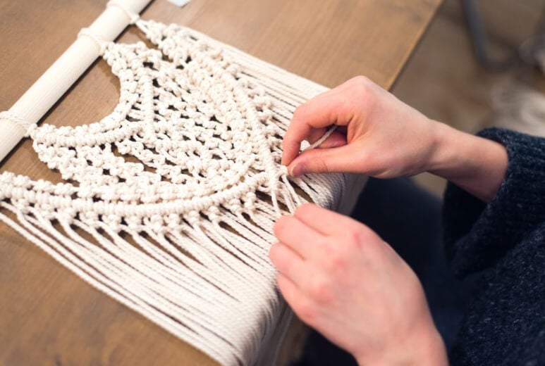 hands weaving macrame panels