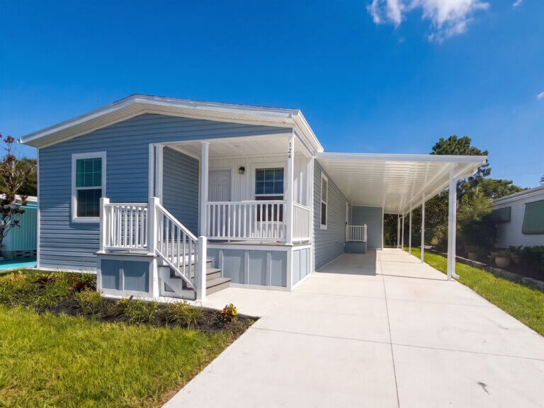 The exterior of a manufactured home for sale in Sun Valley featuring a front porch and car port.