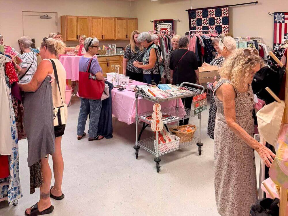 Women shopping inside the Pink Hanger pop up boutique at Cypress Lakes Village.