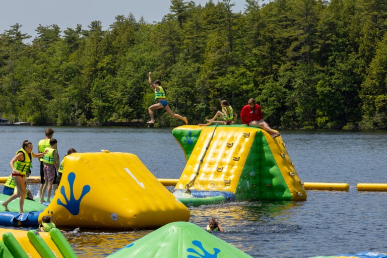 kid jumping off water park in to lake