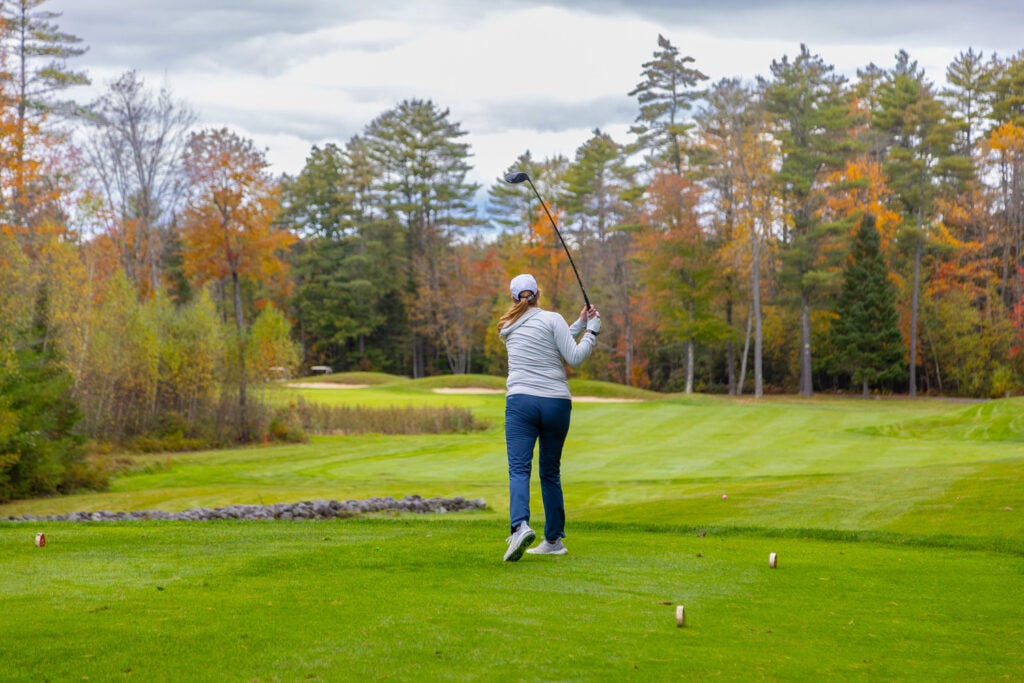 Woman golfing in the fall