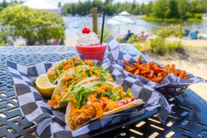 Fish Tacos with sweet potato fries and frozen drink on table