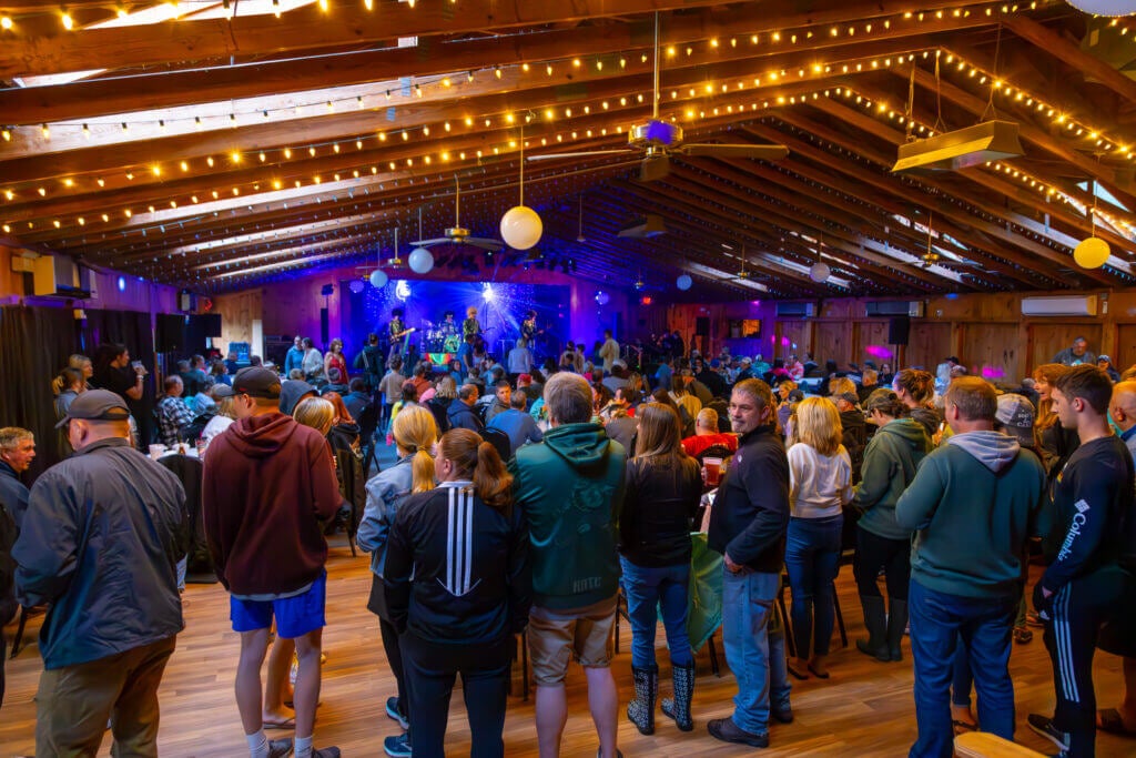 Crowd watching a band in a clubhouse at Point Sebago Resort in Casco, Maine.