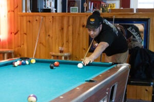 Man shooting pool in a bar.