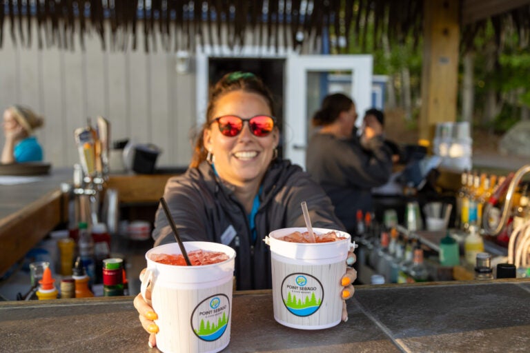 Tiki bar bartender serving drink in two buckets