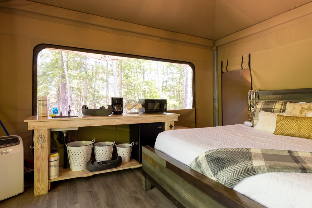 Kitchenette and bed in glamping tent