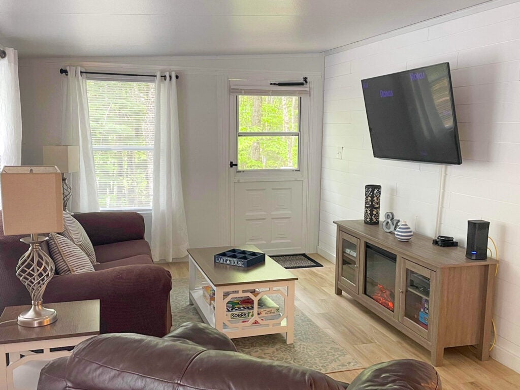 Living room with couch, television, and back door