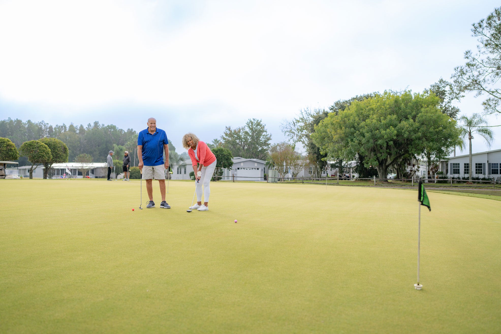 Two people on the putting green in Lakeland, Florida, at Big Cypress Golf Club.