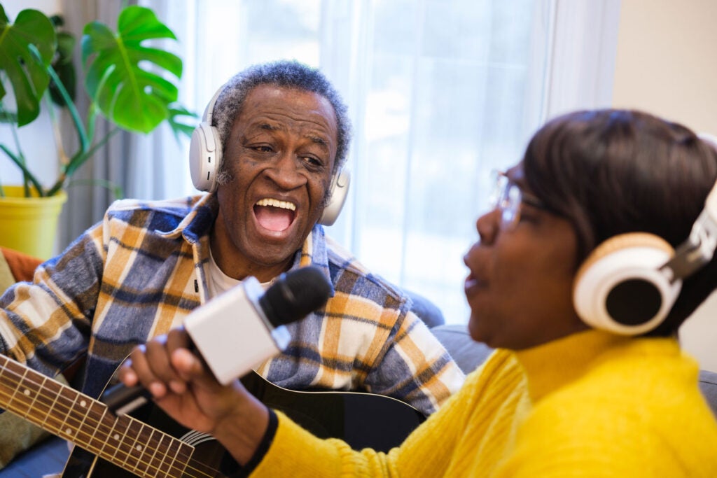 Senior couple singing karaoke