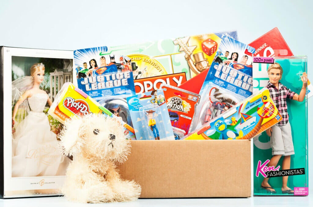 Toys, including dolls, games, and action figures, being collected for a toy drive.
