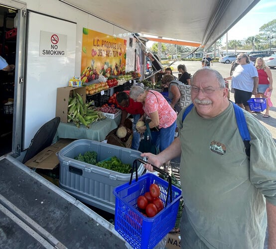 Residents shopping for locally grown produce by L.C Produce LLC at the weekly farmers market at Rolling Greens Village in Ocala, FL.