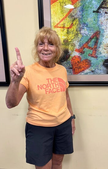 Resident gestures number one after winning a card game at Rolling Greens Village in Ocala, Florida