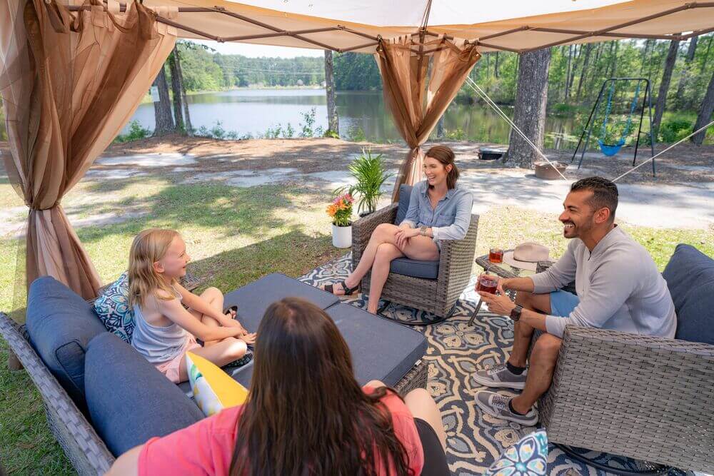Campers sitting around having drinks at Lake Jasper RV Park, a South Carolina RV resort with lake views.