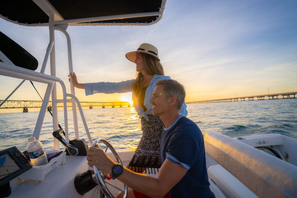 couple boating at sunset