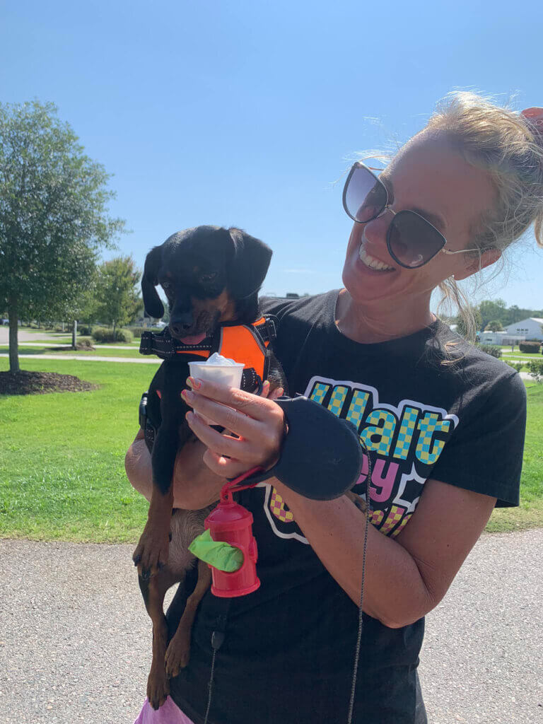 Guest at CreekFire RV Resort In Georgia holding small dog.