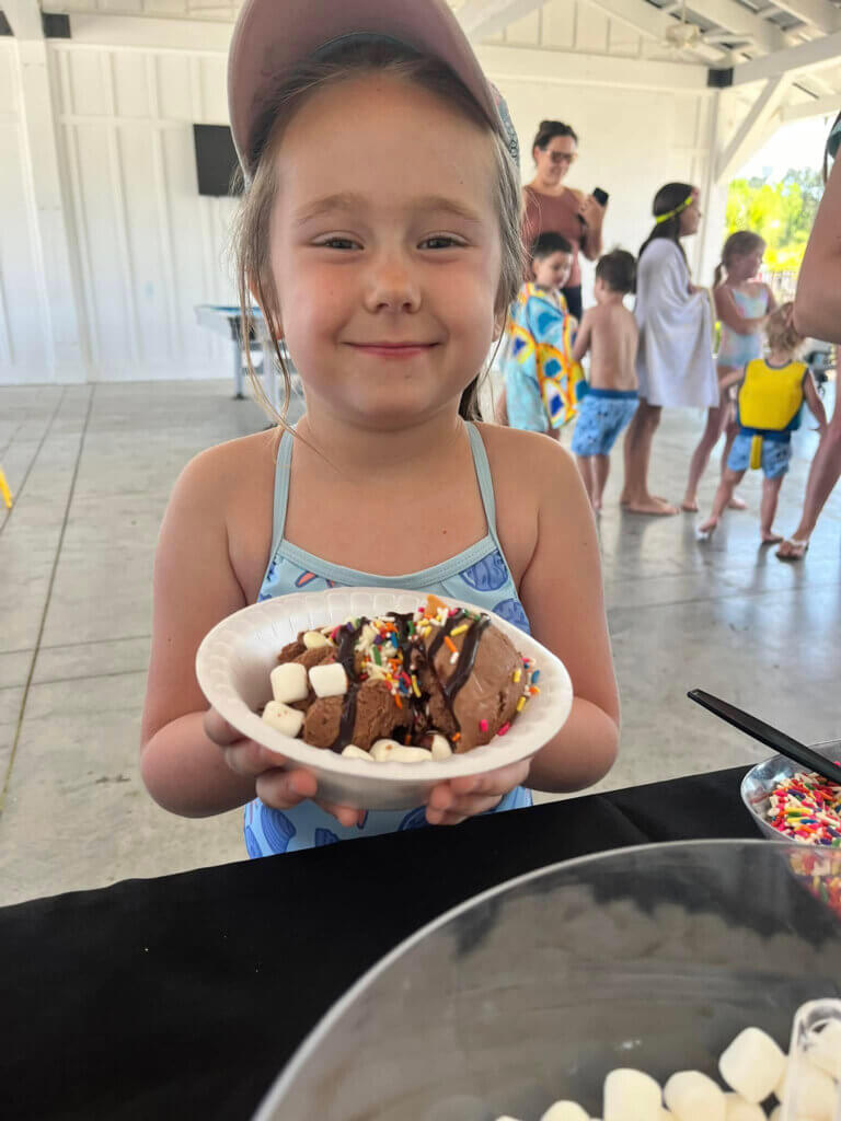 Guest at CreekFire RV Resort holding a sundae from the ice cream bar activity