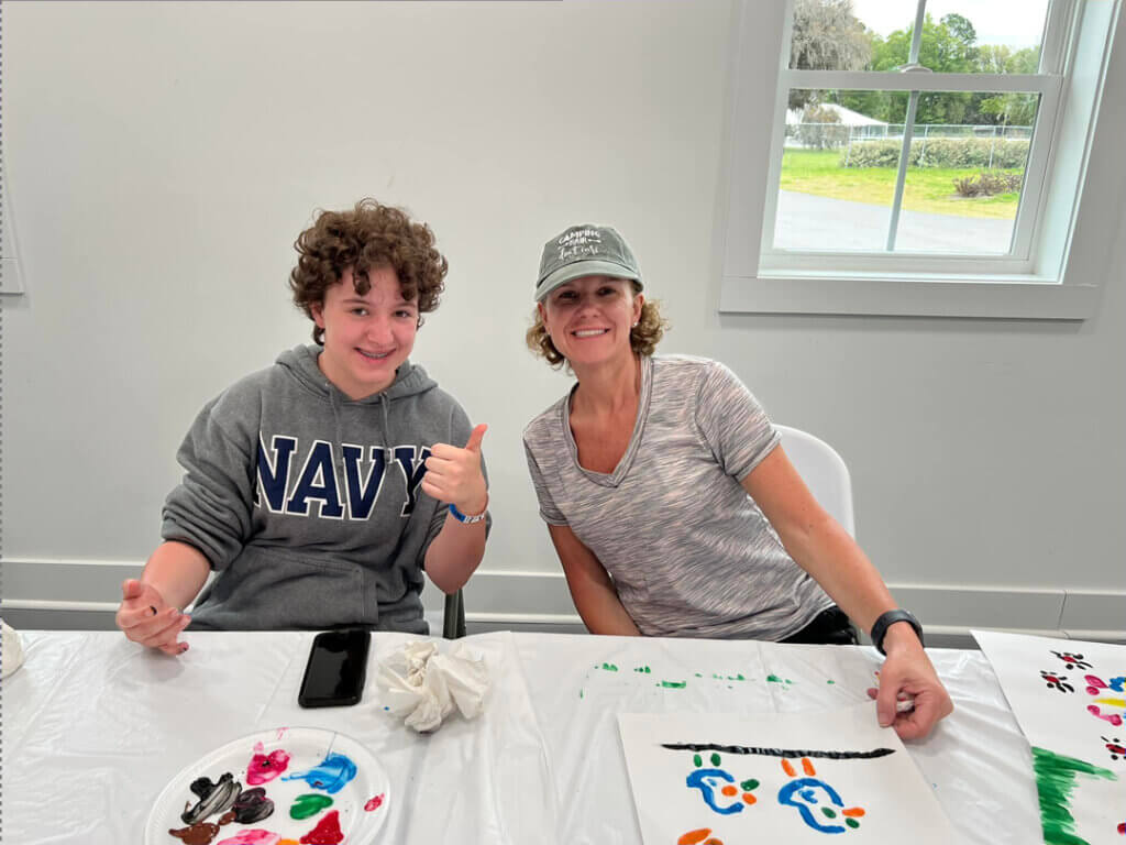 Mom and son painting during lifestyle activity at CreekFire RV Resort