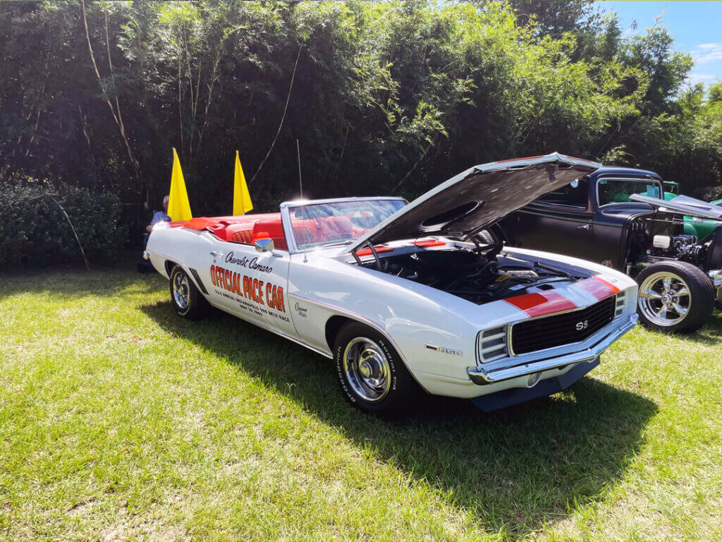 white 1969 Chevrolet Camaro convertible with the hood open, displaying "Official Pace Car" text on its side, parked at CreekFire RV