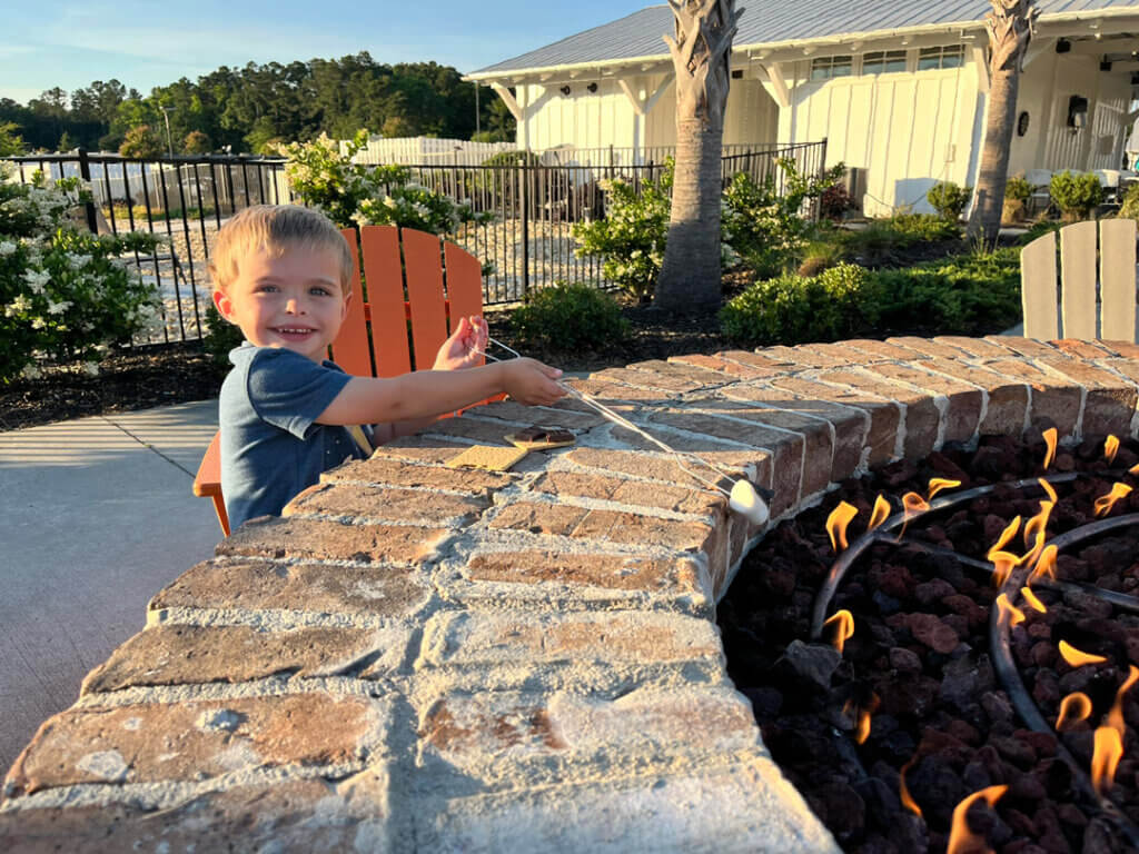 Child roasting Marshmallows around the fire pit at CreekFire RV Resort