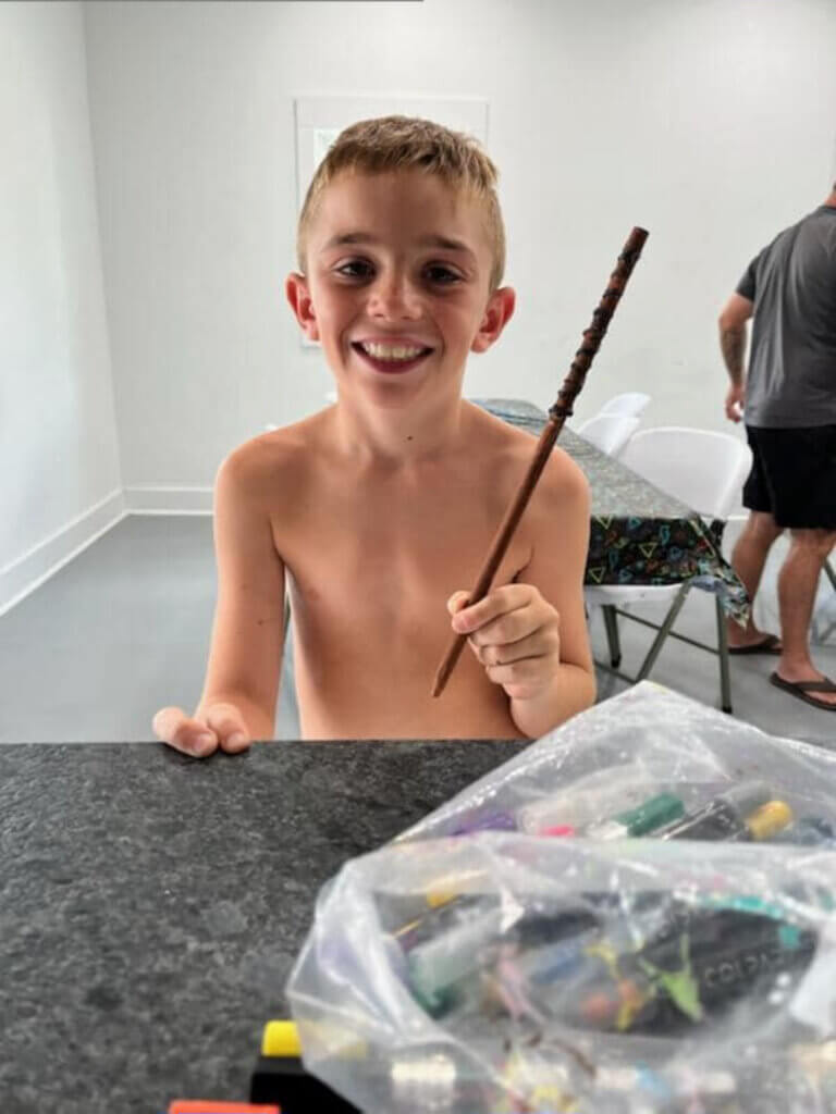 Young boy making a wizard wand at a craft activity for themed weekends at CreekFire RV Resort outside of Savannah, GA.