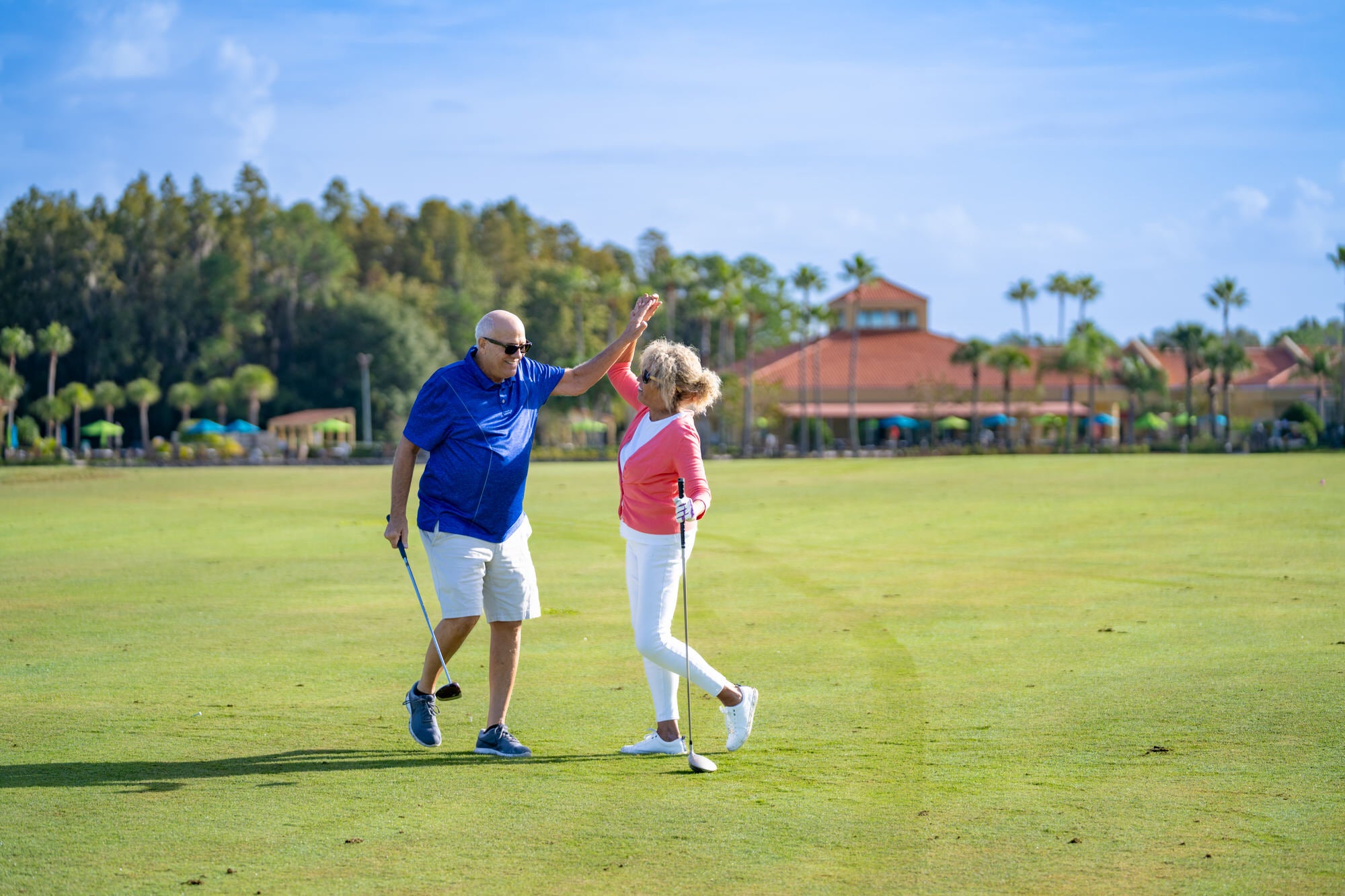 Couple high-five golf course